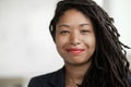 Portrait of smiling businesswoman with dreadlocks, head and shoulders