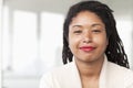 Portrait of smiling businesswoman with dreadlocks, head and shoulders