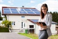 Businesswoman Filling Document In Front Of House Royalty Free Stock Photo