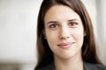 Portrait of smiling businesswoman, head and shoulders