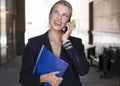 Portrait of a smiling businesswoman talking phone outdoor. Royalty Free Stock Photo