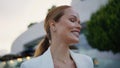 Portrait smiling businesswoman walking evening street in elegant white suit. Royalty Free Stock Photo