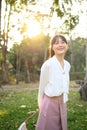 Portrait of smiling businesswoman walking on tropical park and looking away Royalty Free Stock Photo