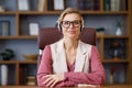 Portrait of smiling businesswoman wearing headset sitting in office. Happy customer support phone operator at call Royalty Free Stock Photo