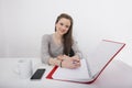 Portrait of smiling businesswoman writing notes at desk in office Royalty Free Stock Photo