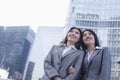 Portrait of smiling businesswomen linking arms, outdoors, Beijing