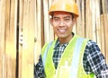 Portrait of a smiling carpenter holding wood Royalty Free Stock Photo