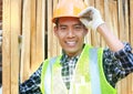 Portrait of a smiling carpenter holding wood Royalty Free Stock Photo