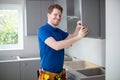 Portrait Of Carpenter Installing Luxury Modern Fitted Kitchen Royalty Free Stock Photo