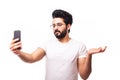 Portrait of a smiling casual arab man making video call on phone and open palm over white background