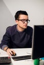 Portrait of smiling casual businessman working with computer in the office