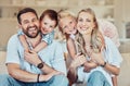 Portrait of smiling caucasian family relaxing together on a sofa at home. Carefree playful little son and daughter Royalty Free Stock Photo