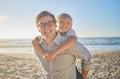 Portrait of smiling caucasian father carrying little son on his shoulders on a beach with. Adorable, happy, white boy Royalty Free Stock Photo