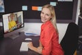 Portrait of smiling caucasian female teacher using computer on video call with schoolboy