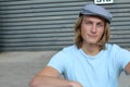 Portrait of a smiling Caucasian man in newsboy hat looking to camera with copy space