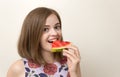 Portrait of smiling caucasian woman girl biting red cut watermelon in her hand. Healthy lifestyle, fruit vegetarian diet.