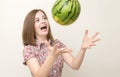 Portrait of smiling caucasian woman girl catching or throwing green watermelon. Healthy lifestyle, fruit vegetarian diet.