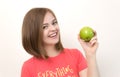 Portrait of smiling caucasian woman girl with green apple in her hand. Healthy lifestyle, fruit vegetarian diet.