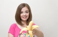 Portrait of smiling caucasian woman girl offering yellow banana in her hand. Healthy lifestyle, fruit vegetarian diet.Portrait of Royalty Free Stock Photo