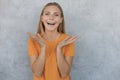 Portrait of smiling chearful beautiful girl looking at camera over gray background Royalty Free Stock Photo