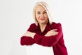 Portrait of smiling cheerful happy middle-aged blonde woman sitting on chair isolated on white Royalty Free Stock Photo