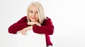 Portrait of smiling cheerful happy middle-aged blonde woman sitting on chair isolated on white Royalty Free Stock Photo