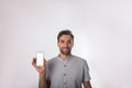 Portrait of a smiling cheerful man looking in camera and holding cell telephone with blank mockup copy space display Royalty Free Stock Photo