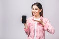 Portrait of a smiling cheerful woman showing blank smartphone sc Royalty Free Stock Photo