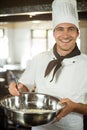 Portrait of smiling chef mixing dough Royalty Free Stock Photo