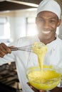 Portrait of smiling chef mixing dough Royalty Free Stock Photo