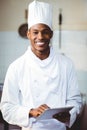 Portrait of smiling chef using digital tablet Royalty Free Stock Photo