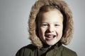 Portrait of Smiling child in fur hood and winter jacket. fashion kid.children.parka.little boy winter style Royalty Free Stock Photo