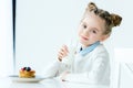 portrait of smiling child with glass of milk in hand and homemade pancakes with honey and berries Royalty Free Stock Photo