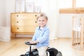 Portrait smiling  child riding toy vintage car. Funny kid playing at home. Summer vacation and travel concept. little boy driving Royalty Free Stock Photo