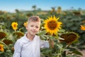 Portrait smiling child with sunflower in summer sunflower field on sunset. Kids happiness concept Royalty Free Stock Photo