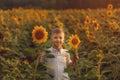 Portrait smiling child with sunflower in summer sunflower field on sunset. Kids happiness concept Royalty Free Stock Photo