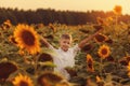 Portrait smiling child with sunflower in summer sunflower field on sunset. Kids happiness concept Royalty Free Stock Photo