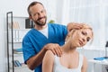 portrait of smiling chiropractor stretching neck of woman Royalty Free Stock Photo