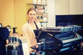 Portrait of smiling coffee shop owner standing behind counter while looking at camera Royalty Free Stock Photo