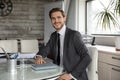 Portrait smiling confident businessman sitting at table in modern office Royalty Free Stock Photo