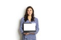 Portrait, smiling confident pretty woman long sleeve dress, holding grey laptop device and typing while standing against solid whi Royalty Free Stock Photo