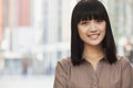 Portrait of smiling, confident, young woman with bangs and long hair, outdoors in Beijing, China