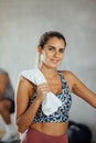 Portrait of smiling confident young woman standing in gym looking at camera. Royalty Free Stock Photo