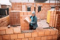 Portrait of smiling construction worker building walls, mason building house Royalty Free Stock Photo