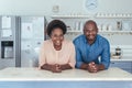 Content African couple leaning on their kitchen island at home Royalty Free Stock Photo