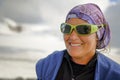 Portrait of smiling contented strong and independent woman in mountain sunglasses