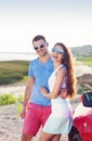 Portrait of a smiling couple with at beach by the car Royalty Free Stock Photo