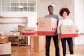 Portrait Of Smiling Couple Carrying Boxes Into New Home On Moving Day Royalty Free Stock Photo