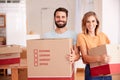 Portrait Of Smiling Couple Carrying Boxes Into New Home On Moving Day Royalty Free Stock Photo
