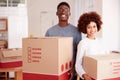 Portrait Of Smiling Couple Carrying Boxes Into New Home On Moving Day Royalty Free Stock Photo